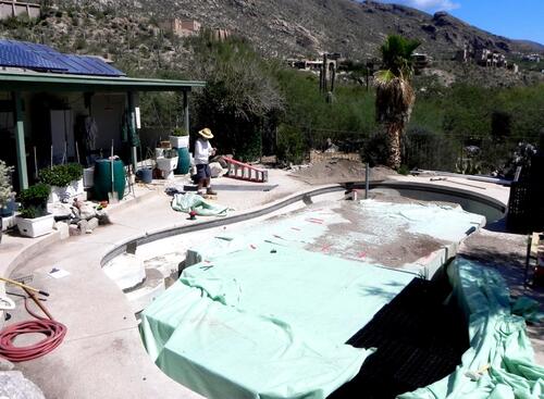 Waterproof liner is laid in bottom of pool. Plastic boxes are inserted to form a rigid structure and liner is wrapped over the top.